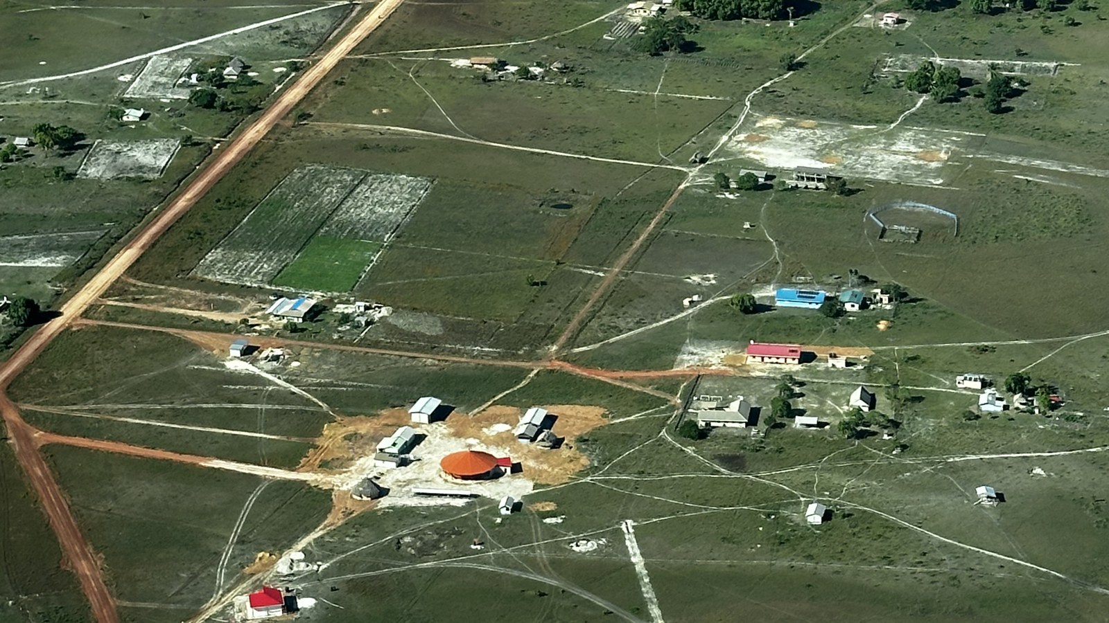 Rupununi carbon money: the Georgetown-Lethem Road runs past Annai's homes, farm plots and round meeting house.